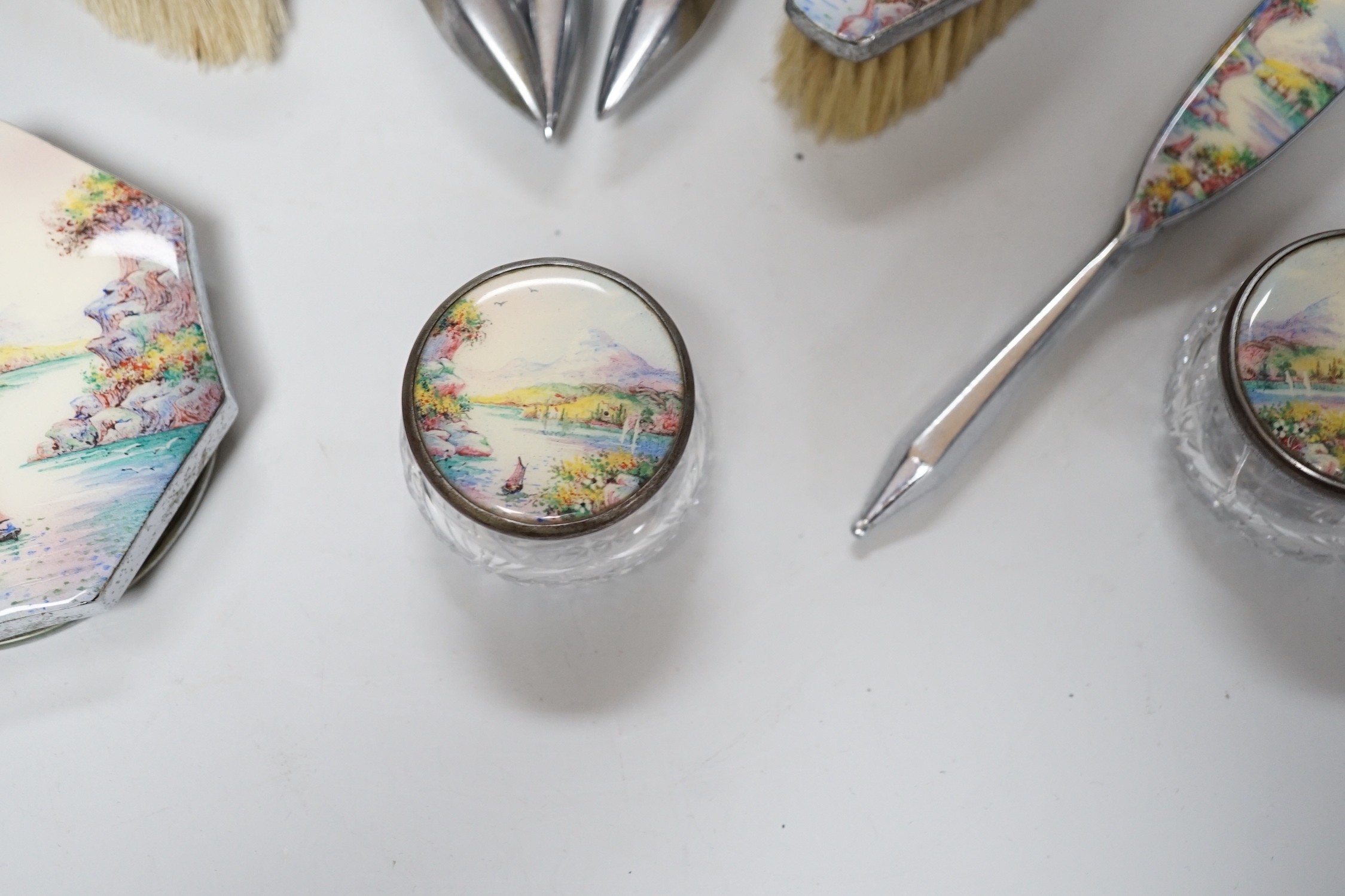 A twelve piece chrome plated and enamel dressing table set